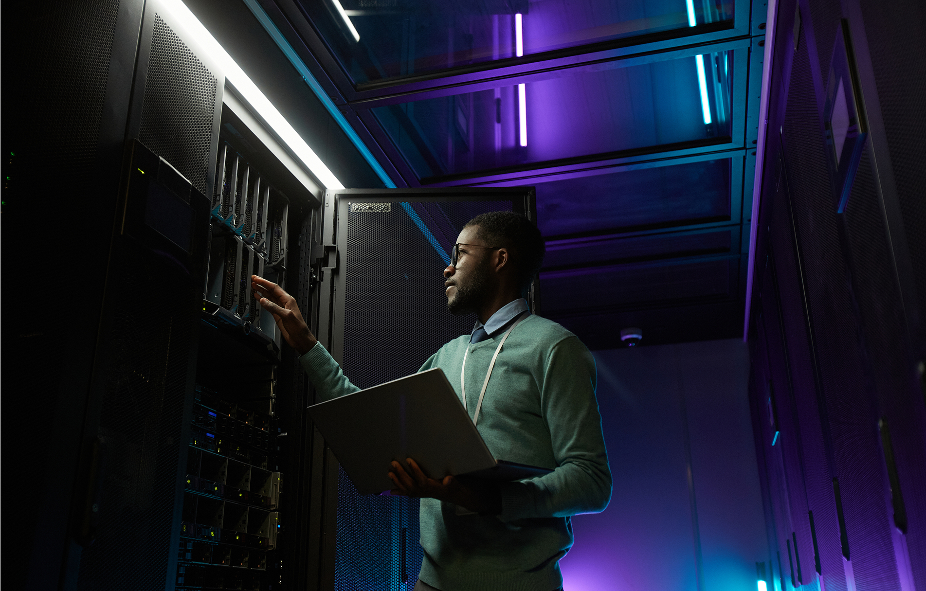 Engineer reviewing infrastructure in a server hall