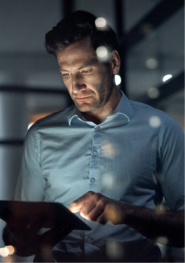 Engineer reviewing security console with neon glow